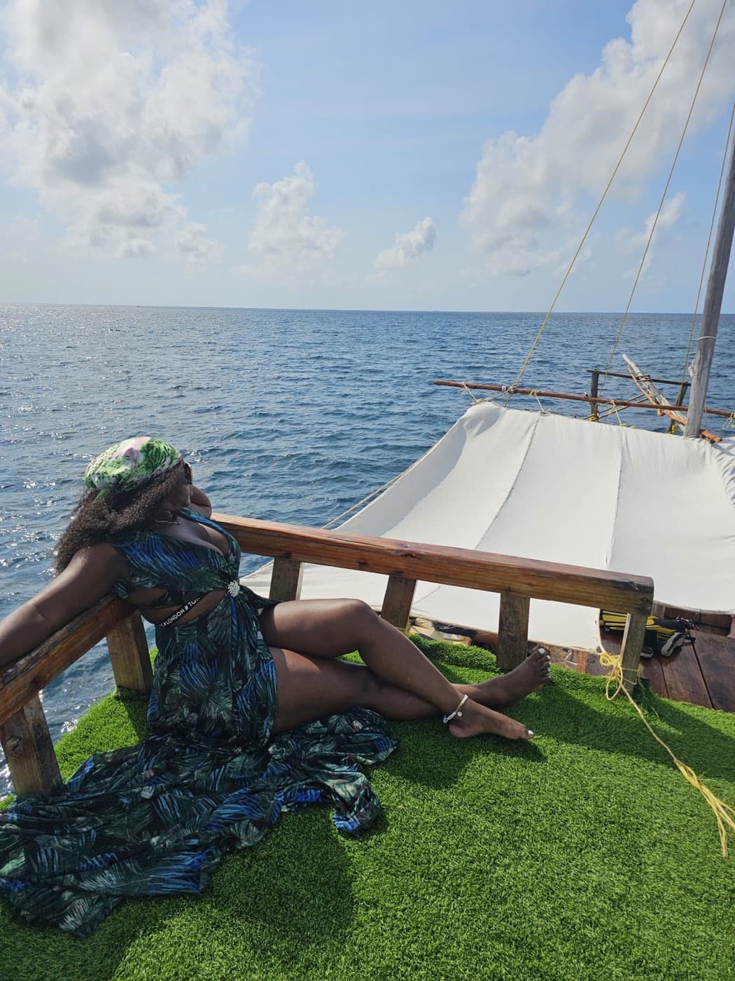 A traveler relaxing aboard a dhow on the Indian Ocean
