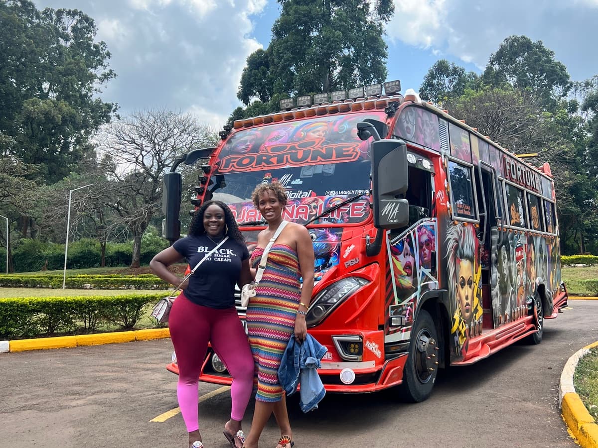 Travelers beside a brightly painted Nairobi matatu
