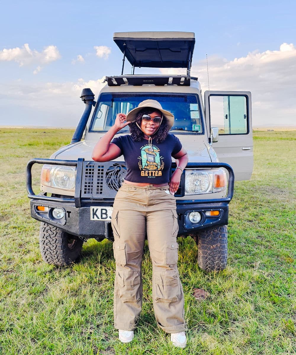 A traveler beside a safari vehicle in Kenya